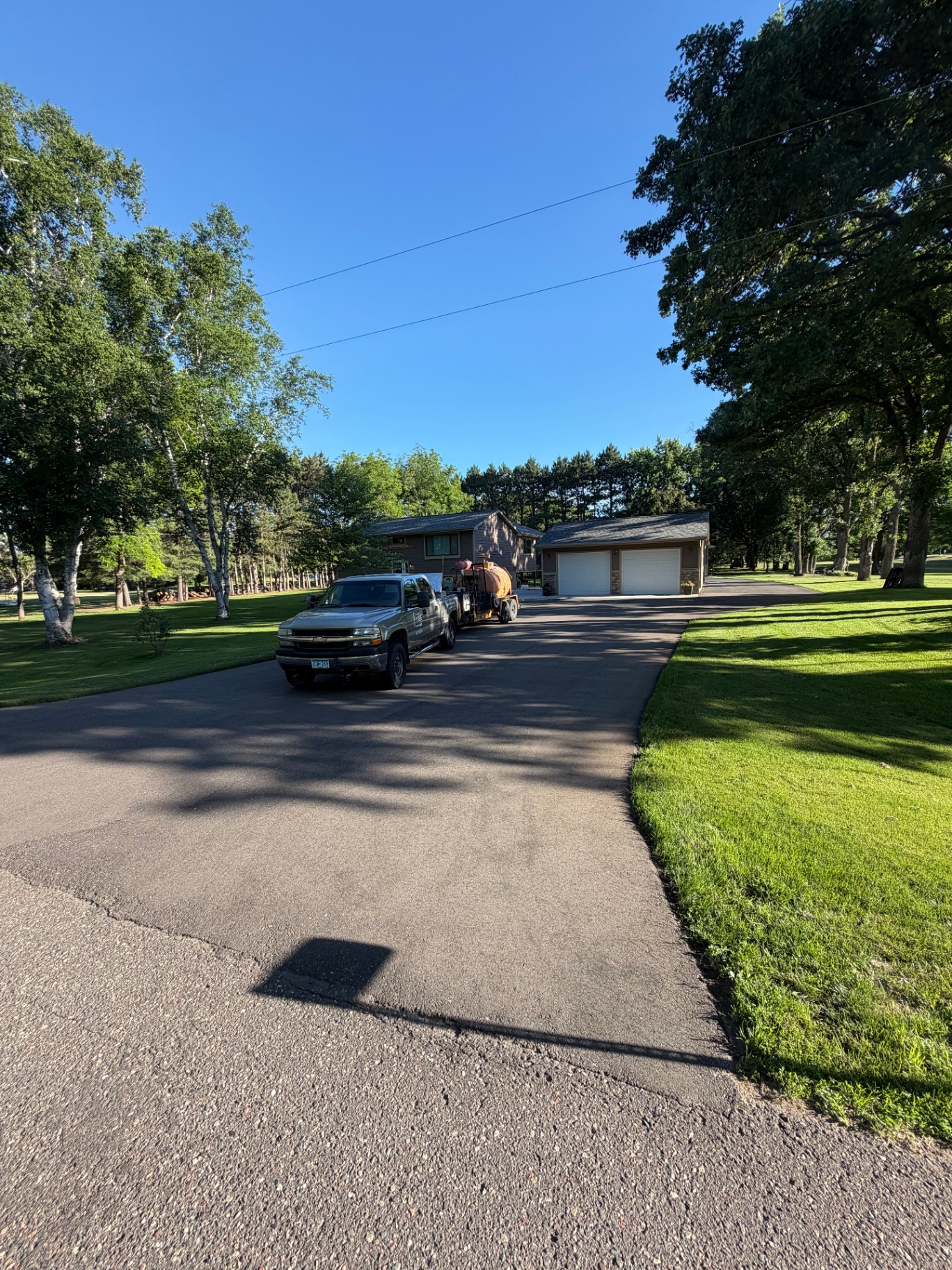 Prater Companies seal coating truck and tank parked in a residential driveway